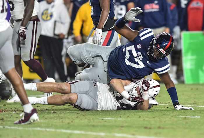 Ole Miss OL Micah Pettus (57) tackles Mississippi State LB Sherman Timbs (34) in the 2022 Egg Bowl at Ole Miss' Vaught-Hemingway Stadium in Oxford, Miss., Thursday, November 24, 2022.